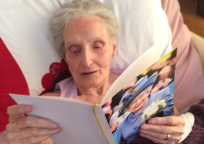 Resident reading her birthday card from the Queen