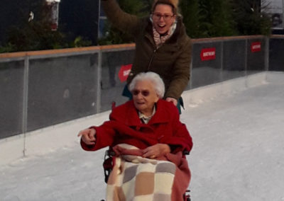 Lady resident and staff member from Meyer House out on the ice at a local ice rink