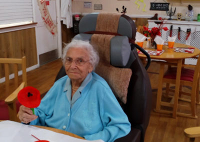 Meyer House resident showing off her handmade Remembrance poppy