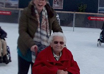 Lady resident and staff member from Meyer House out on the ice at a local ice skating rink