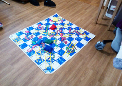 A large snakes and ladders floor mat