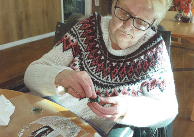 A female resident at Meyer House making a personalised bauble decoration