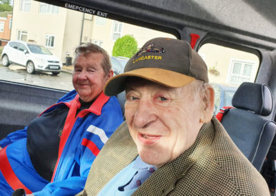 Two male residents from Meyer House sitting on a minibus together