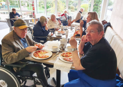 Meyer House residents enjoying pizza for lunch at Polhill Garden Centre