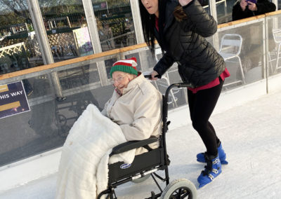 Staff member and resident out on an ice rink