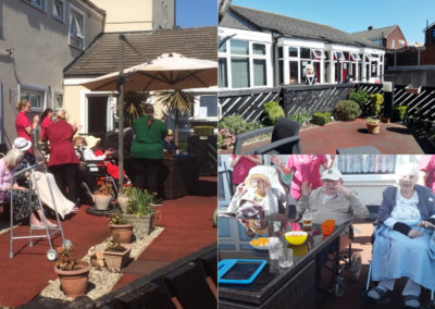Meyer House Care Home residents enjoying live singing outside the Home in the sunshine