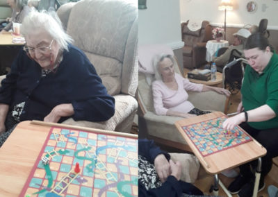 Meyer House Care Home residents enjoying a game of snakes and ladders