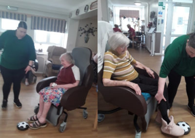 Meyer House Care Home ladies playing seated football from their chairs in the lounge