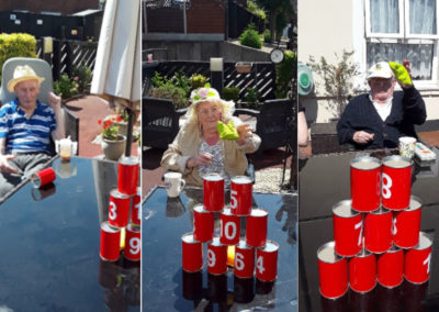 Meyer House Care Home residents playing can skittles in their garden