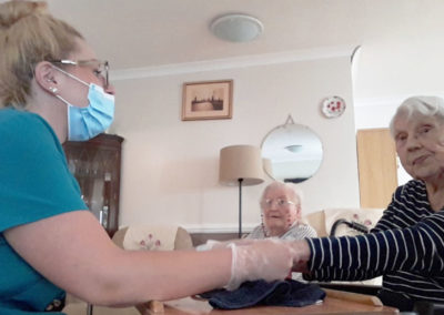 Resident enjoying a hand massage at Meyer House Care Home