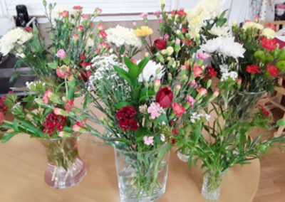 Vases of red, white, yellow and pink flowers