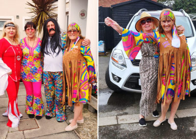 Staff posing in sixties costumes outside Meyer House Care Home