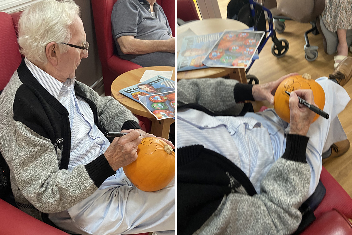 Meyer House Care Home resident sketching a face on a pumpkin